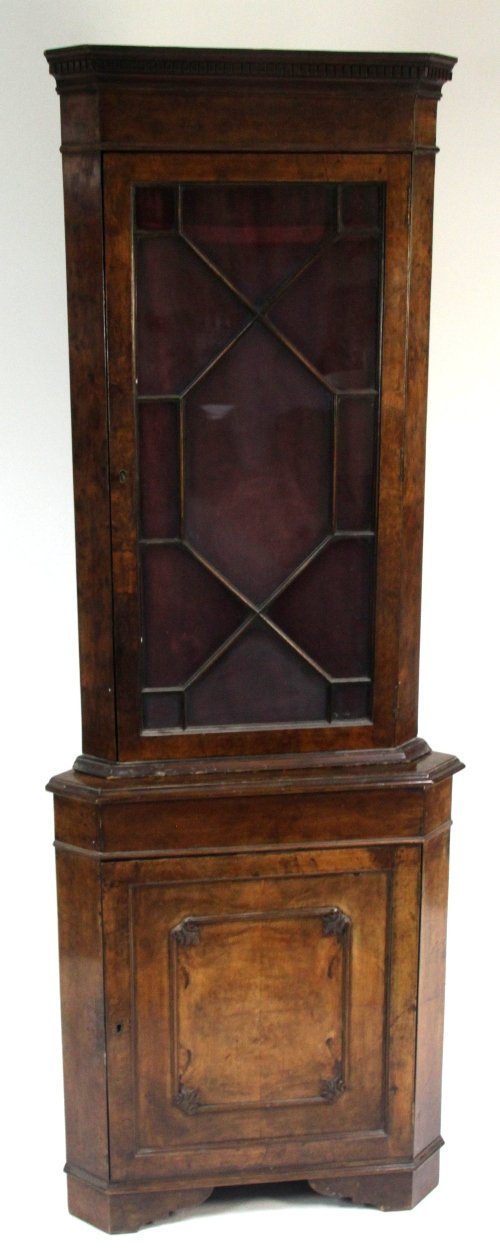 Appraisal: A George III style walnut standing corner cupboard the astragal