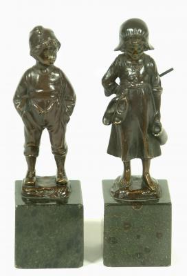 Appraisal: A PAIR OF BRONZE FIGURES modelled as a Dutch boy