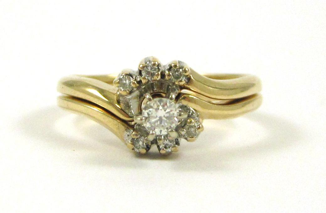 Appraisal: DIAMOND AND FOURTEEN KARAT GOLD WEDDING SET The engagement ring