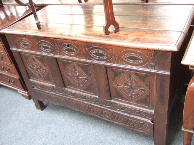 Appraisal: A carved and stained oak coffer circa with a moulded