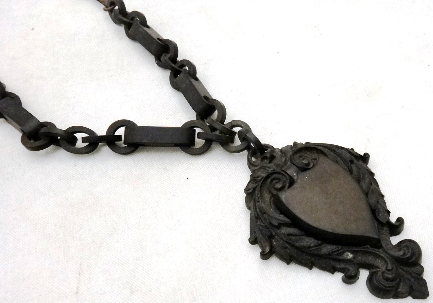 Appraisal: A Victorian vulcanite pendant locket with a neckchain the shield