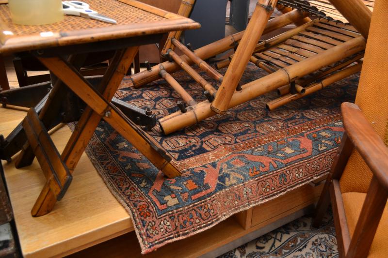 Appraisal: A MIDDLE EASTERN RUG IN ORANGE RED AND BLUE TONES