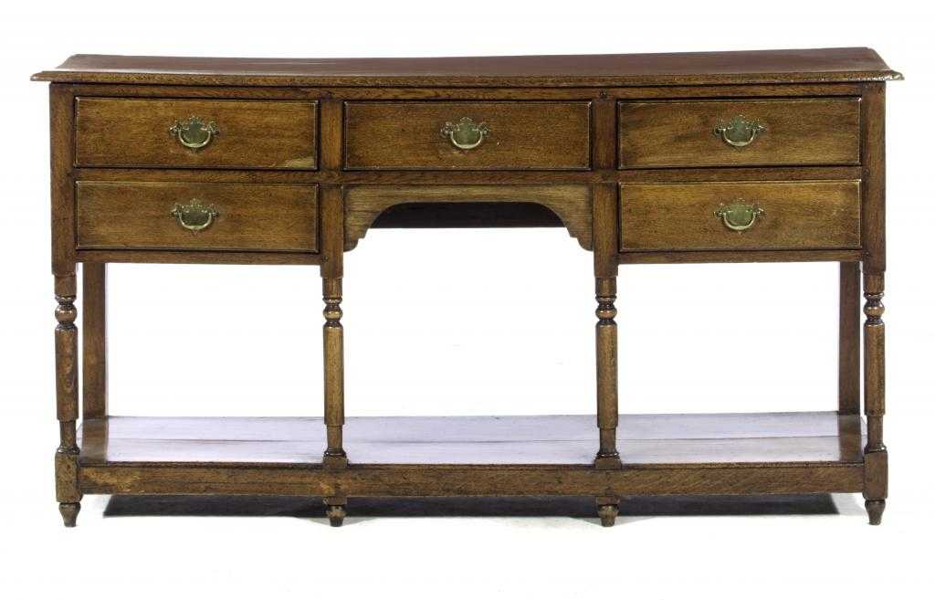 Appraisal: AN OAK DRESSER with five moulded drawers and central arched