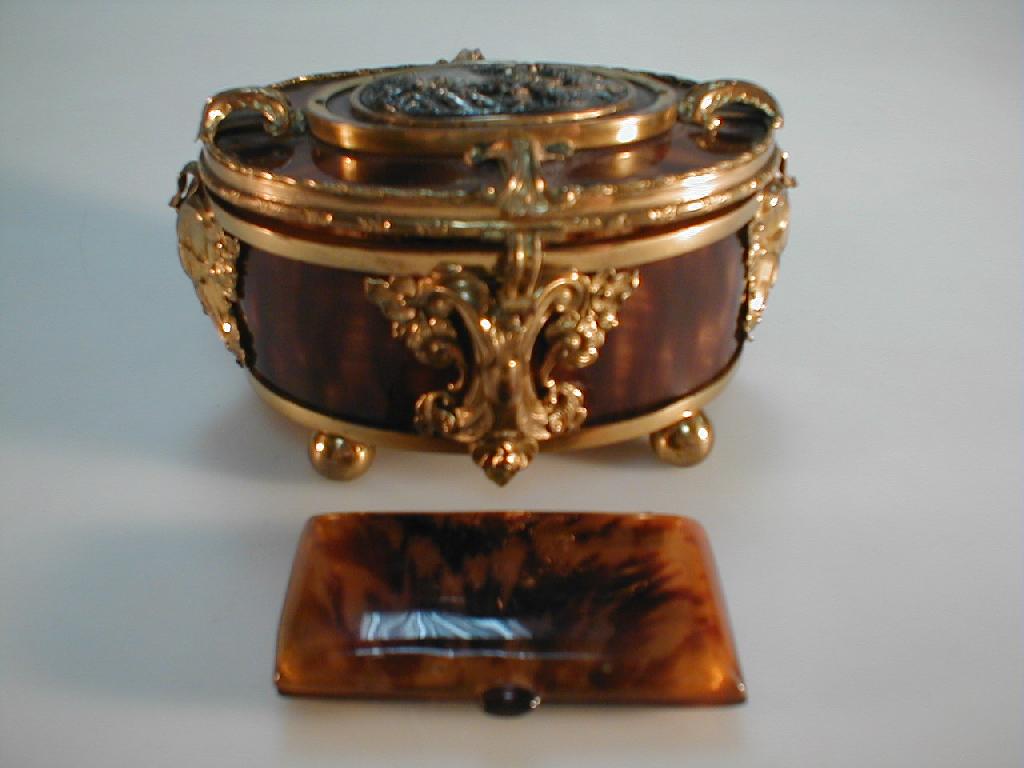 Appraisal: A cast brass and faux tortoiseshell casket of oval form