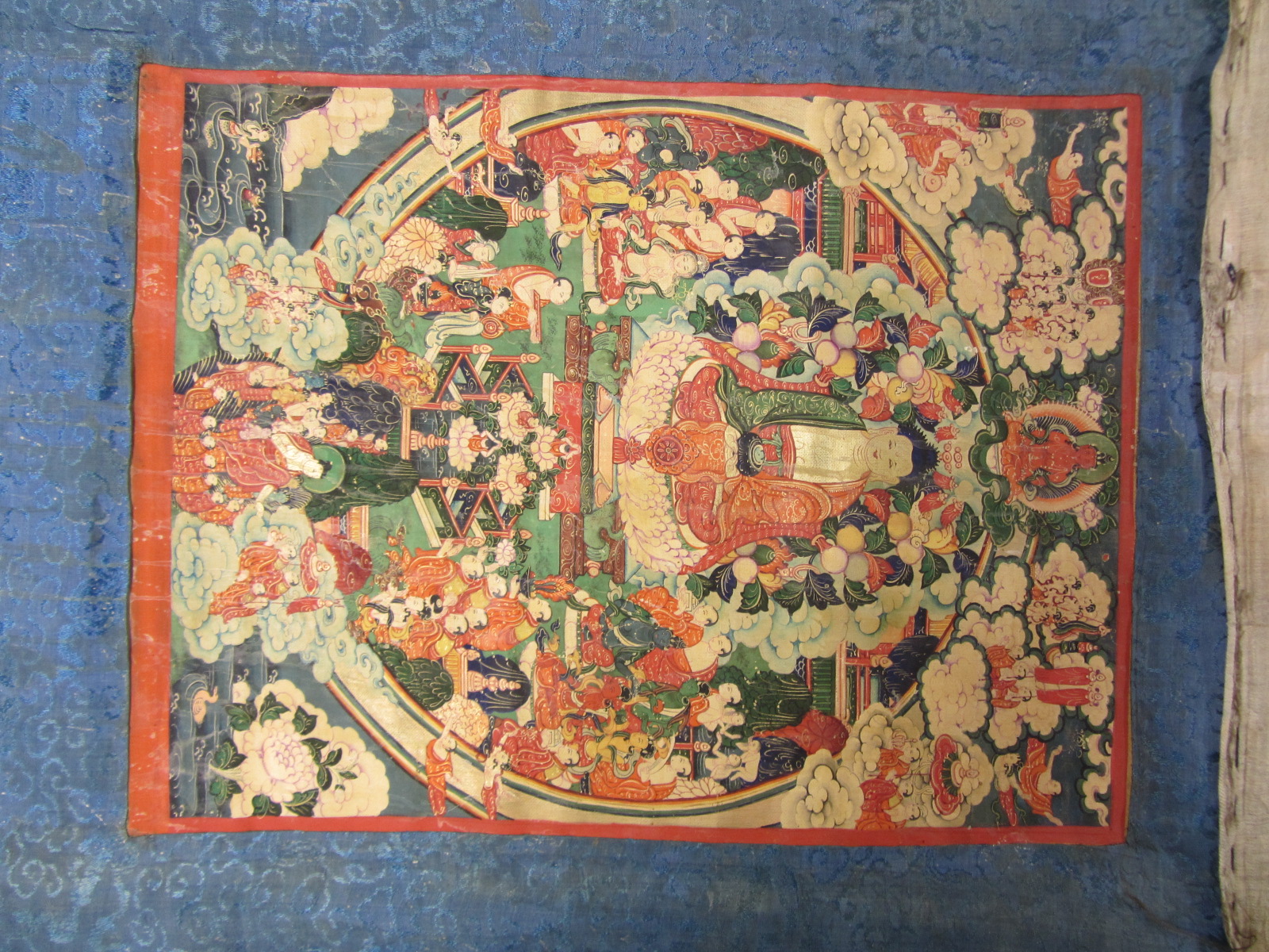 Appraisal: A Tibetan tanka laid on a silk scroll painted with