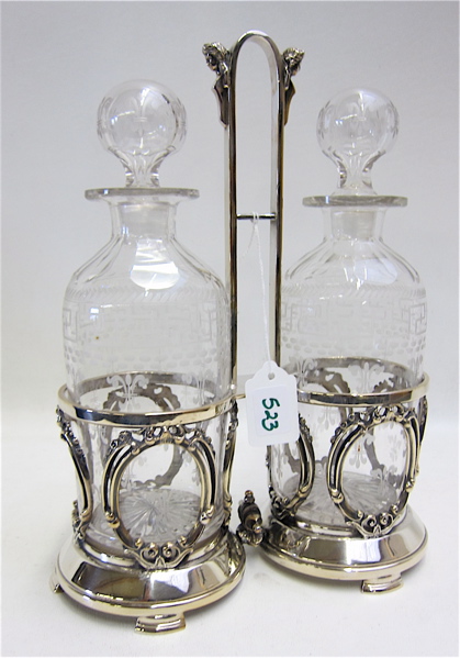 Appraisal: AMERICAN VICTORIAN GLASS DECANTER SET IN SILVER PLATED STAND pair