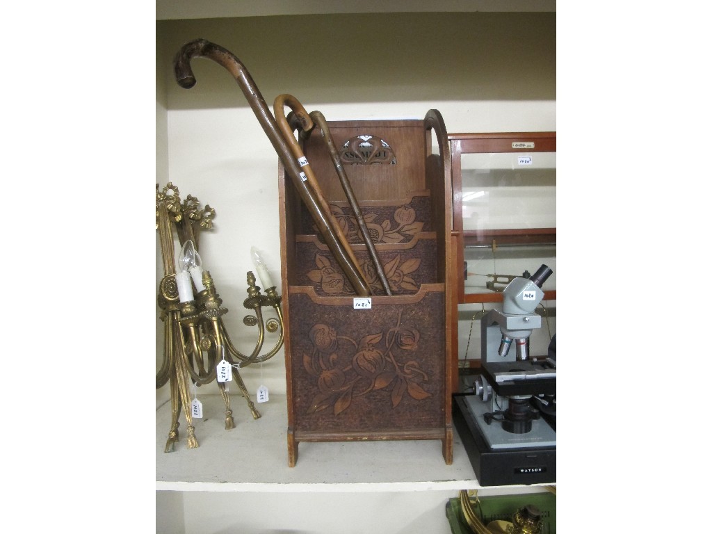 Appraisal: Pokerwork magazine rack with three walking sticks