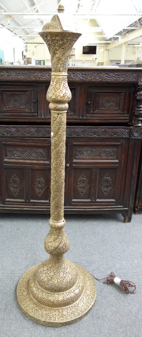 Appraisal: A pierced brass standard lamp probably Egyptian early th century