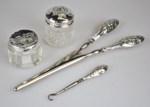 Appraisal: A pair of glove stretchers with cherub's head embossed silver