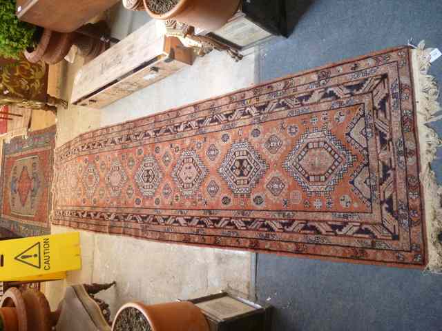 Appraisal: AN EASTERN RUST GROUND RUNNER decorated eight medallions within a