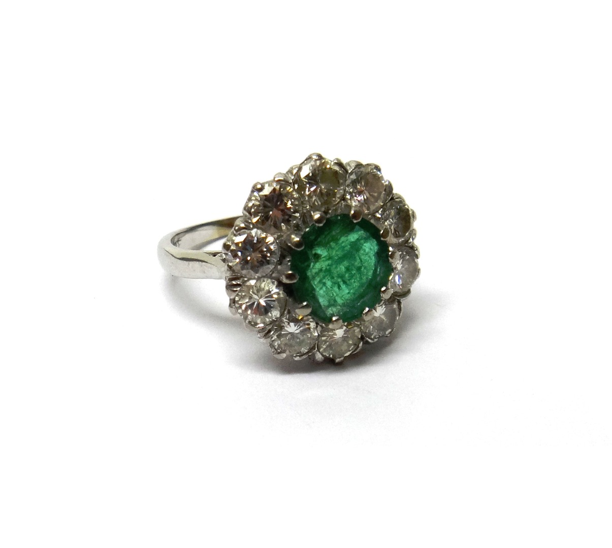 Appraisal: An ct white gold emerald and diamond set circular cluster