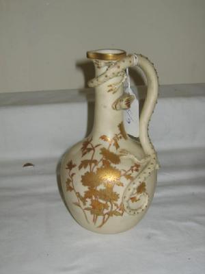 Appraisal: A ROYAL WORCESTER EWER of baluster form with moulded lizard