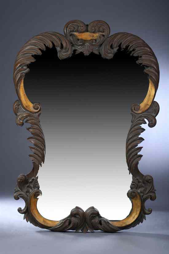 Appraisal: CONTINENTAL STYLE GRAIN-PAINTED AND PARCEL-GILT WALL MIRROR Serpentine foliate-carved frame