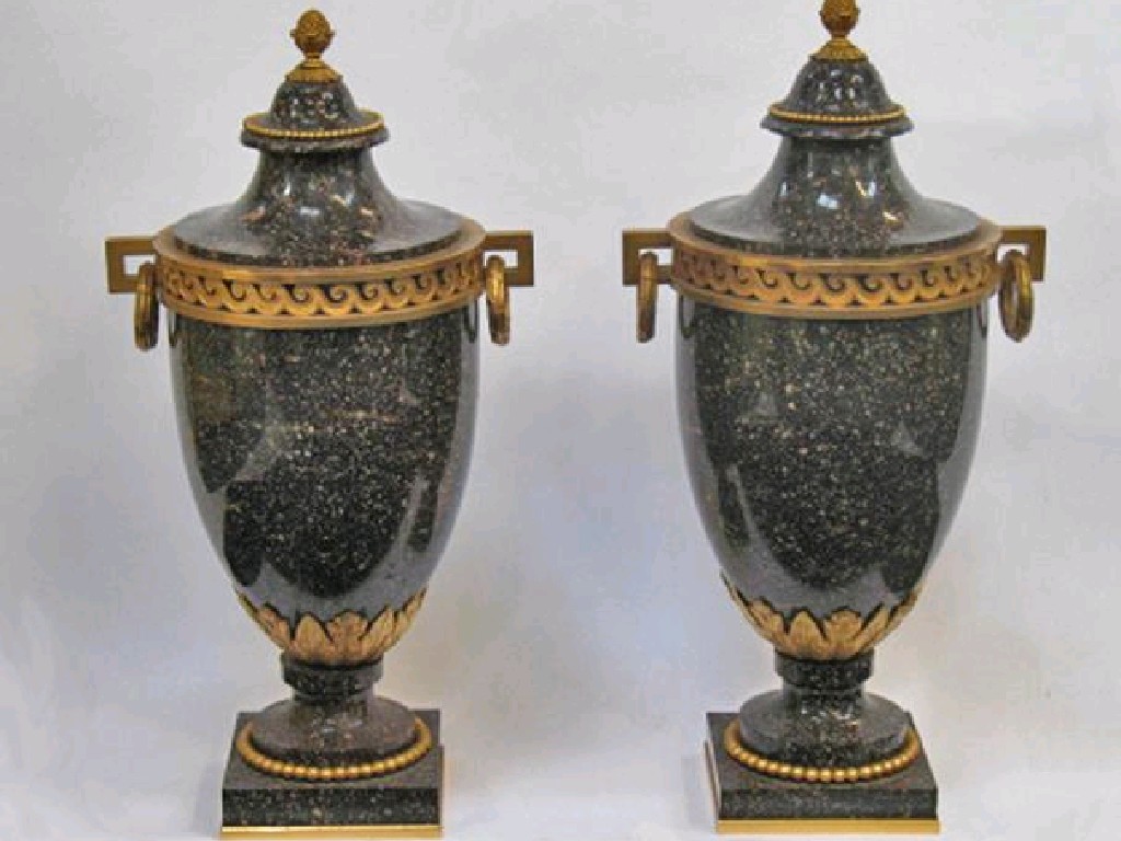 Appraisal: A PAIR OF SWEDISH ORMOLU-MOUNTED PORPHYRY URNS each with a