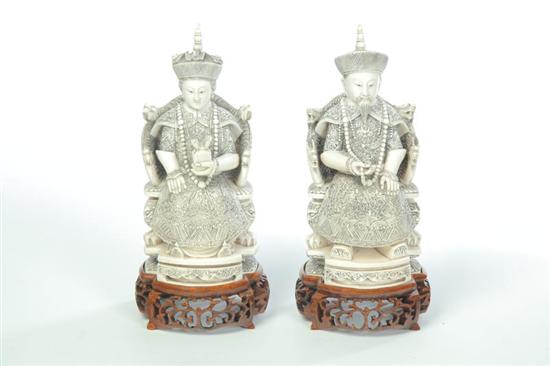 Appraisal: PAIR OF IVORY CARVINGS China early th century Seated emperor