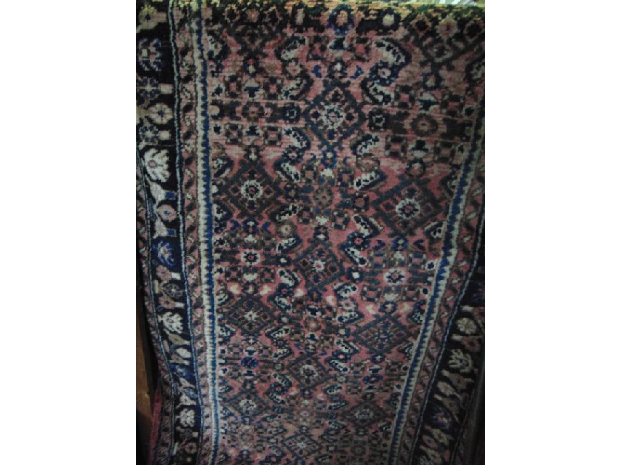 Appraisal: A Persian style wool runner with multi-medallion centre upon a