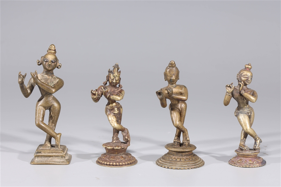 Appraisal: Group of four antique Indian Krishna figures playing the flute