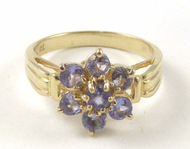 Appraisal: TANZANITE AND TEN KARAT GOLD FLORAL RING set with seven