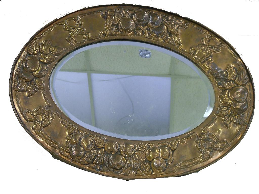 Appraisal: Arts Crafts oval copper framed bevelled edge wall mirror embossed