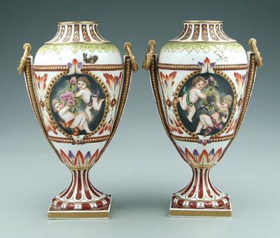 Appraisal: Pair porcelain vases putti frolicking with grapes in oval shield