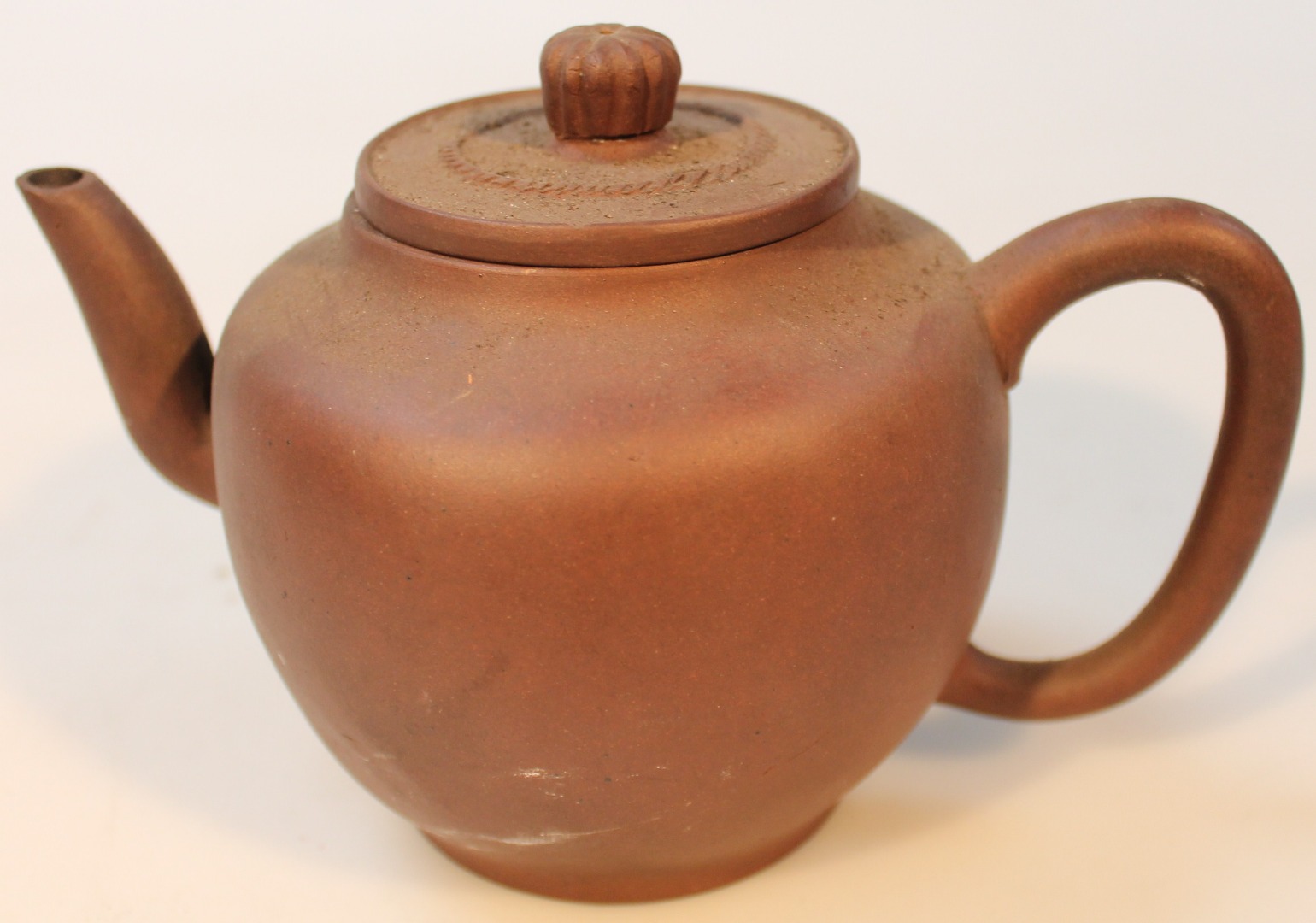 Appraisal: An Chinese Yixing style redware teapot the bulbous body set