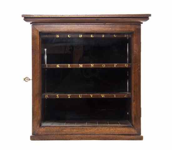 Appraisal: An English Walnut Letter Cabinet having a single glazed door