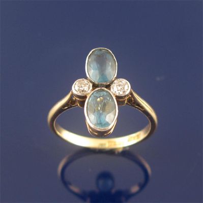 Appraisal: A ct gold ring set with two oval shaped aquamarines