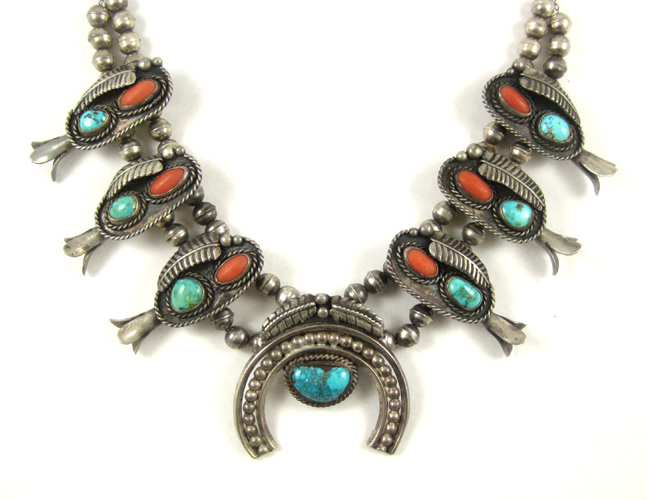 Appraisal: NAVAJO SILVER AND TURQUOISE SQUASH BLOSSOM NECKLACE Seven natural turquoise