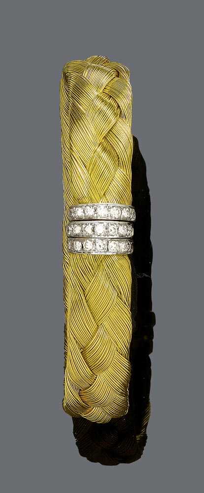 Appraisal: GOLD AND DIAMOND BANGLE Yellow gold g Elegant bangle with