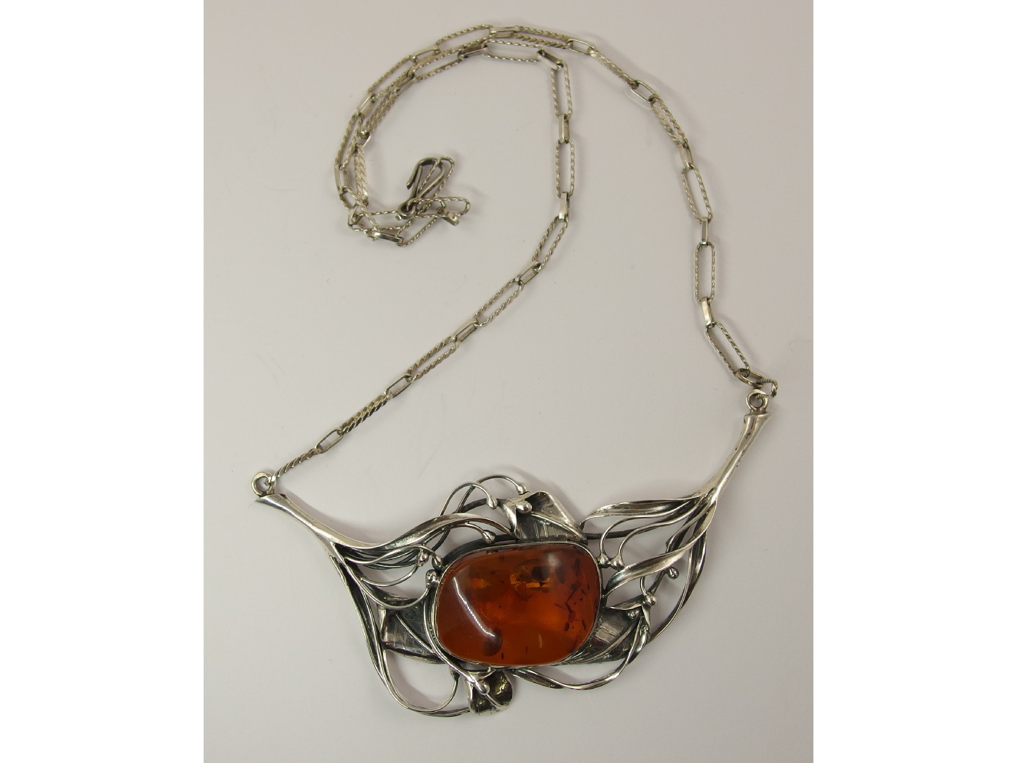 Appraisal: A silver floral designed necklace set with a large amber