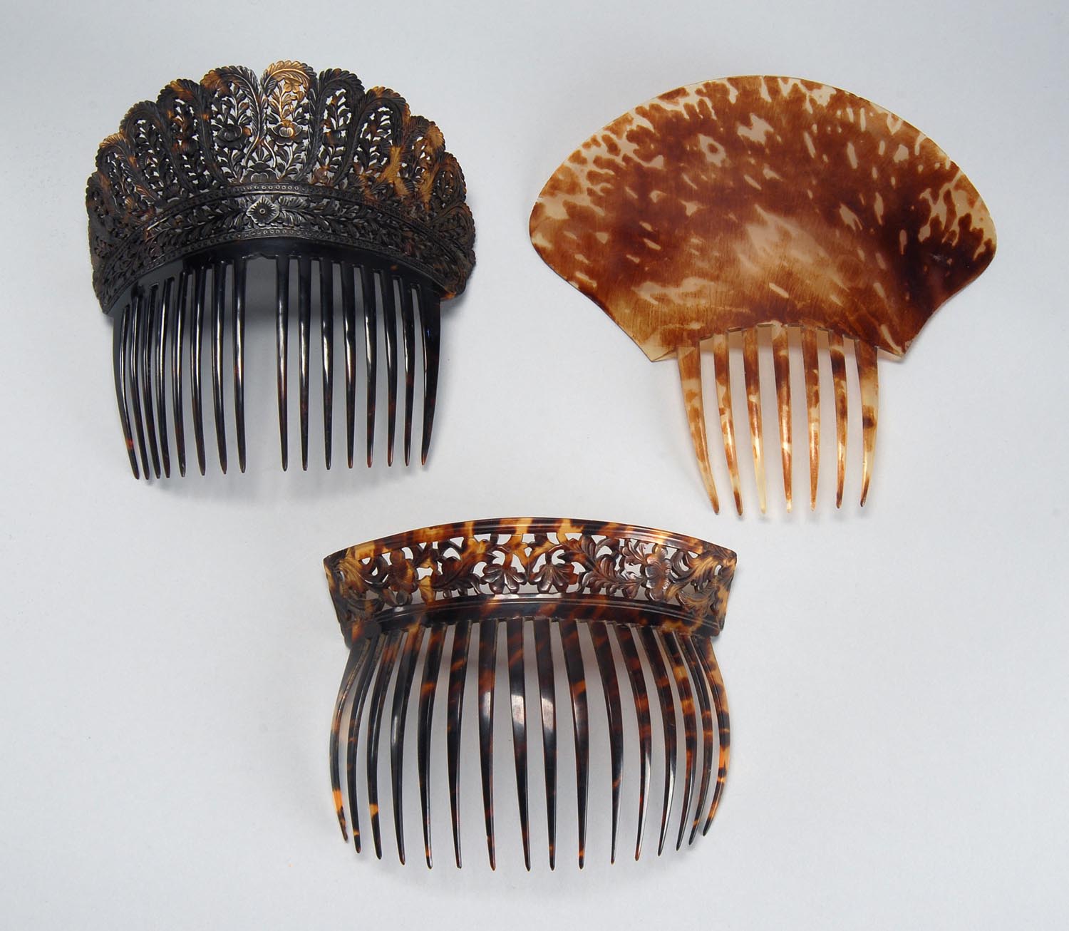 Appraisal: THREE SHELL HAIR COMBS Late th CenturyTwo with carved reticulated