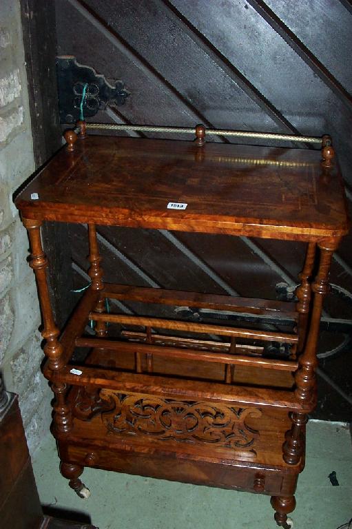 Appraisal: A Victorian walnut Canterbury whatnot with pierced panels turned supports