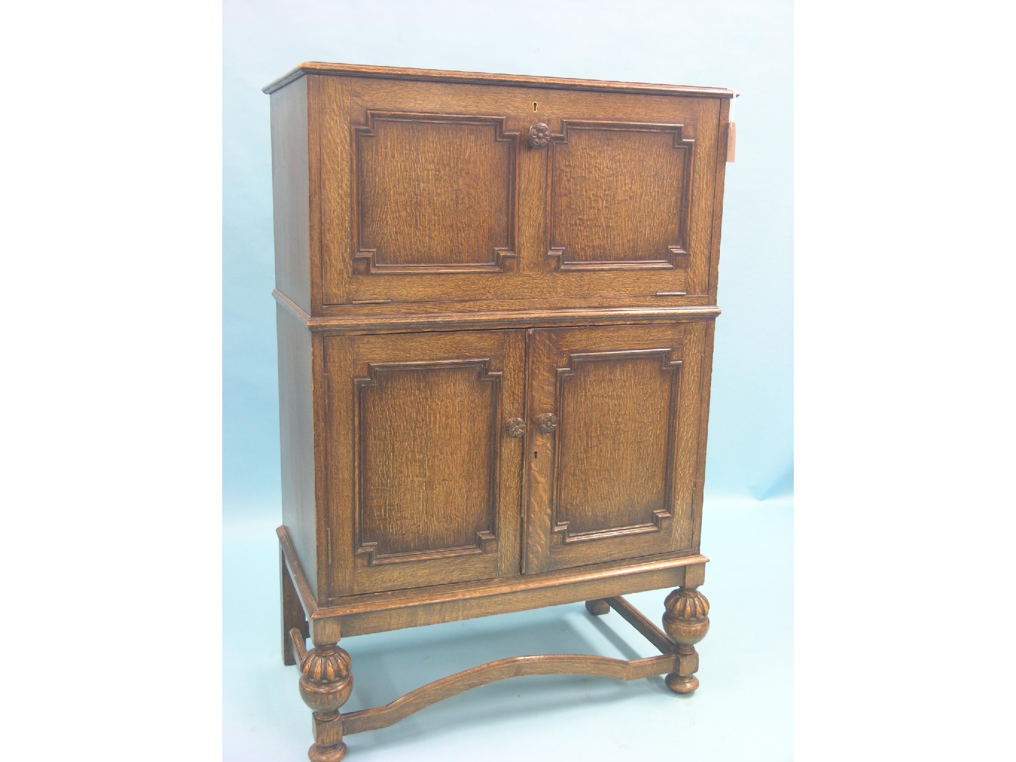 Appraisal: A good quality solid dark oak drinks cabinet panelled construction