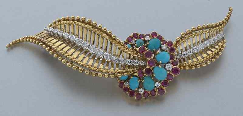 Appraisal: K gold diamond ruby and turquoise broochfeaturing eight cabochon cut