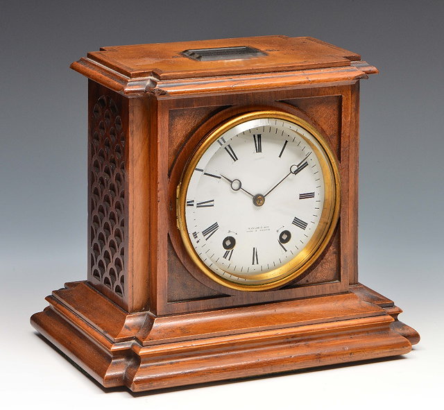 Appraisal: A French walnut mantel clockthe slightly convex white enamel Roman