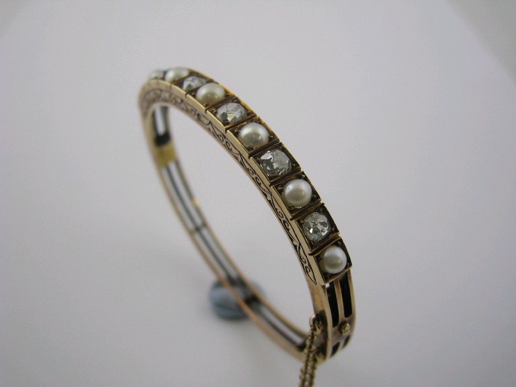 Appraisal: A Diamond and Half Pearl hinged Bangle the front pav