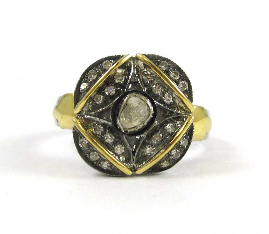 Appraisal: DIAMOND SILVER AND YELLOW GOLD RING The sterling silver and