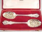 Appraisal: A pair of silver berry spoons in Harrods case Sheffield