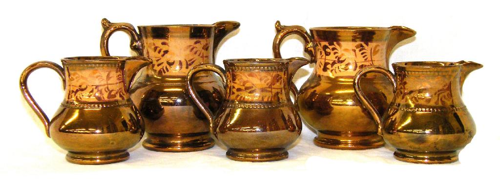 Appraisal: Set of five th century copper lustre jugs