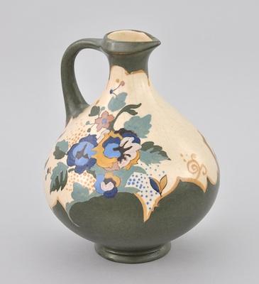 Appraisal: A Gouda Pitcher With a curving handle narrow neck and