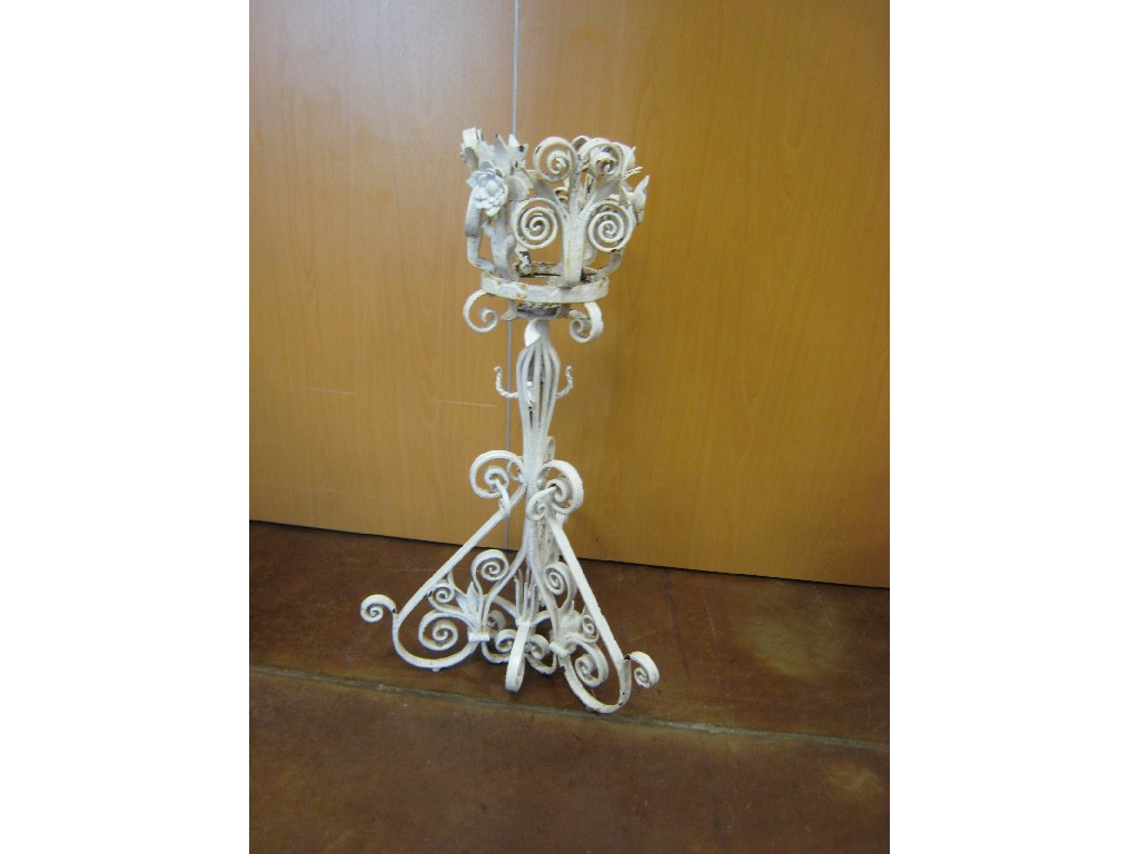 Appraisal: A freestanding painted wrought iron Planter scrollwork designs