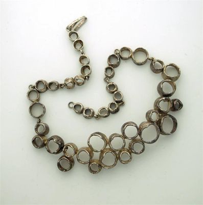 Appraisal: A modern Swedish necklace formed by linked crater-like rings of