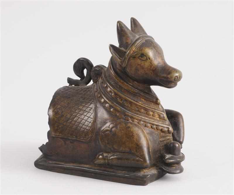 Appraisal: INDIAN BRONZE FIGURE OF A RECUMBENT BULL The hollow-cast half-length