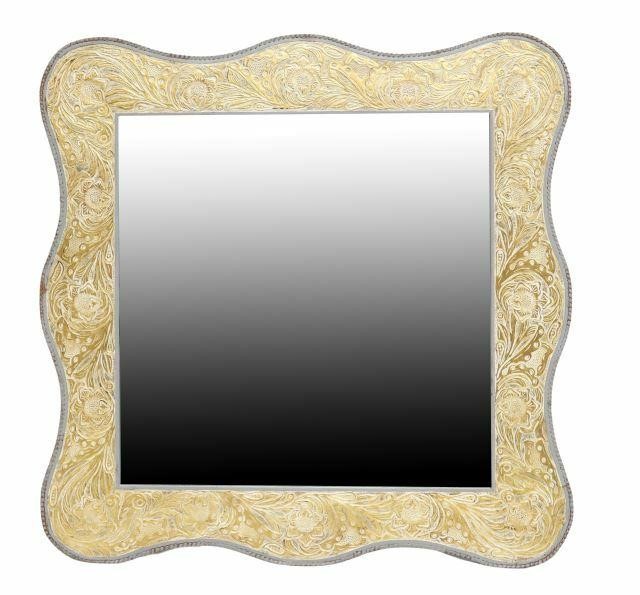 Appraisal: Western style wall mirror late th c shaped leather-clad frame