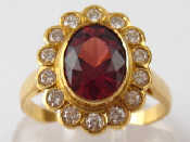 Appraisal: A French hallmarked carat gold garnet and diamond ring the