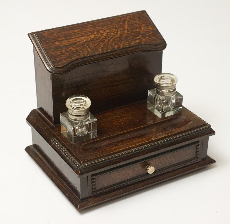 Appraisal: EDWARDIAN OAK DESK TIDY of stepped form the stationery box