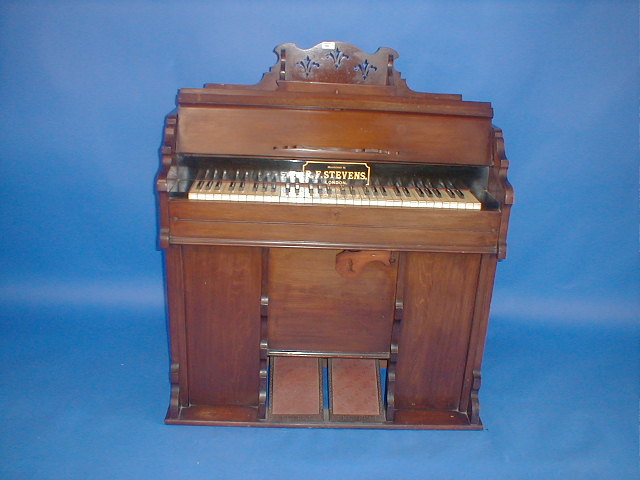 Appraisal: A Victorian walnut cased harmonium manufactured by R F Stevens