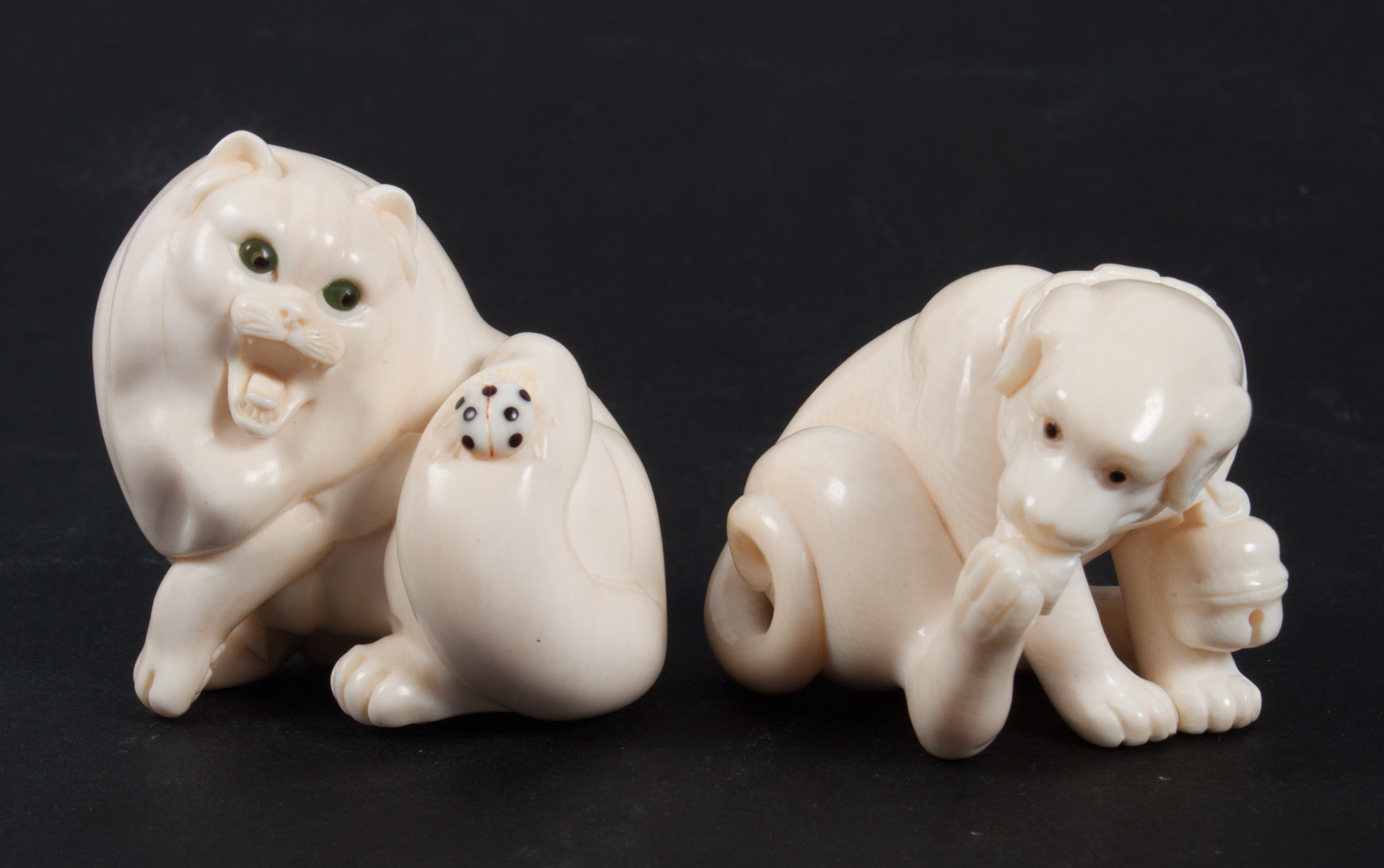 Appraisal: Japanese carved ivory netsuke and figure cat netsuke with ladybug