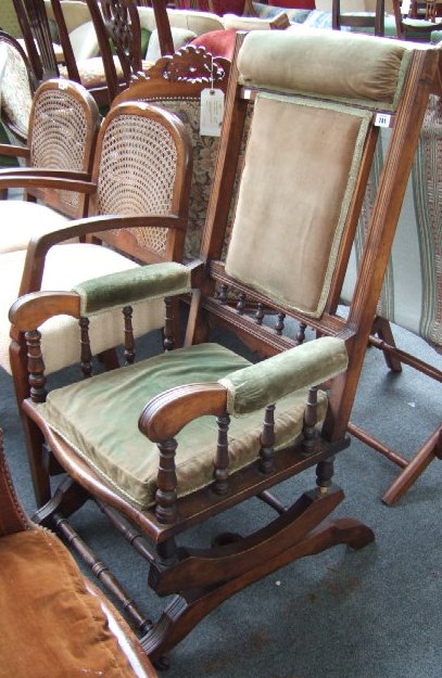 Appraisal: An American style rocking chair with over stuffed back seat