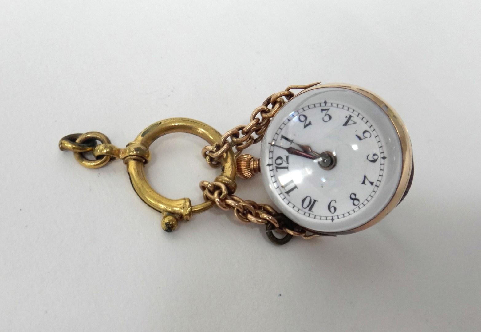 Appraisal: A gold mounted spherical pendant fob watch with an unsigned